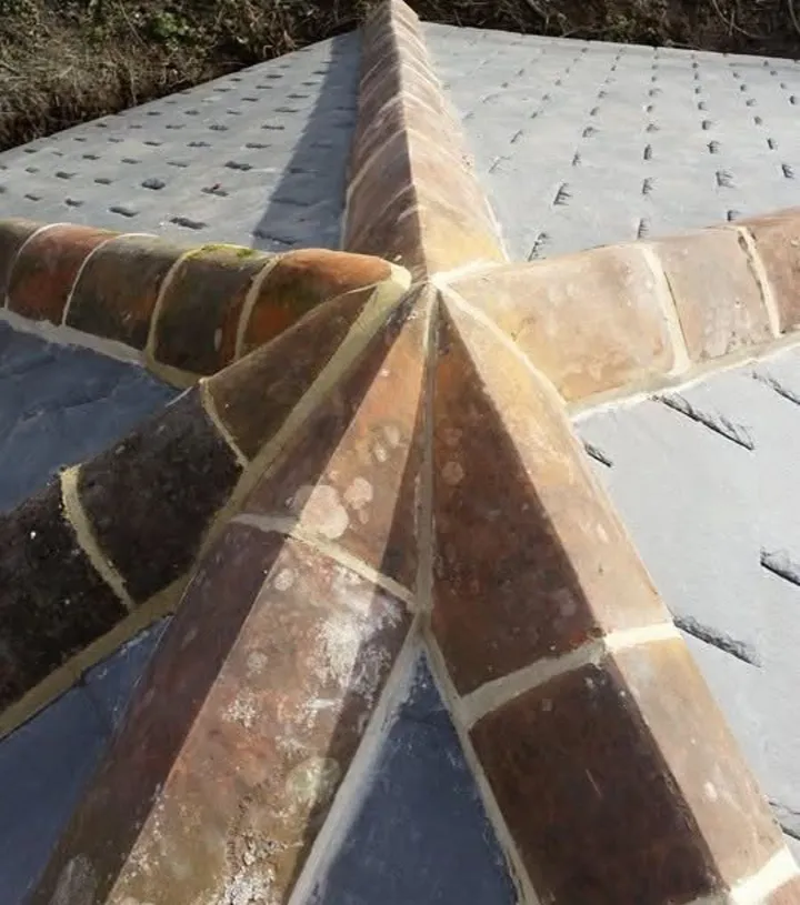 Ornate brick ridge star detail on a slate hipped roof